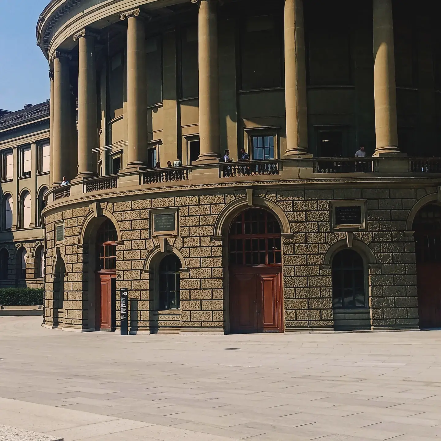 The rounded stone wall and columns of the ETH Zürich main building in strong sunlight