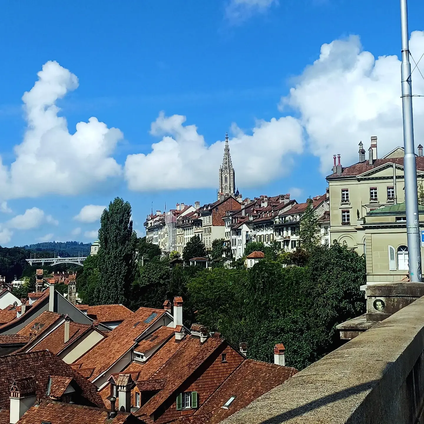 The Zytglogge clock tower in Bern with its gold-numbered dial and astronomical clock against a deep blue sky